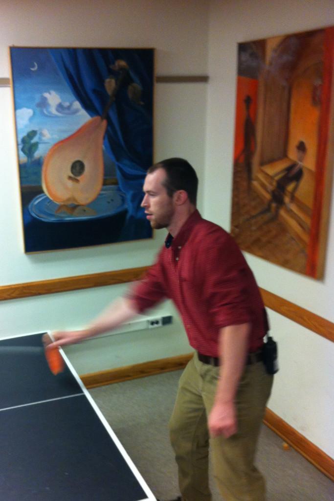 Micah Gibbons, who monitors the Senior Lounge, plays ping pong. Gibbons has been a substitute teacher in several departments at the high school.