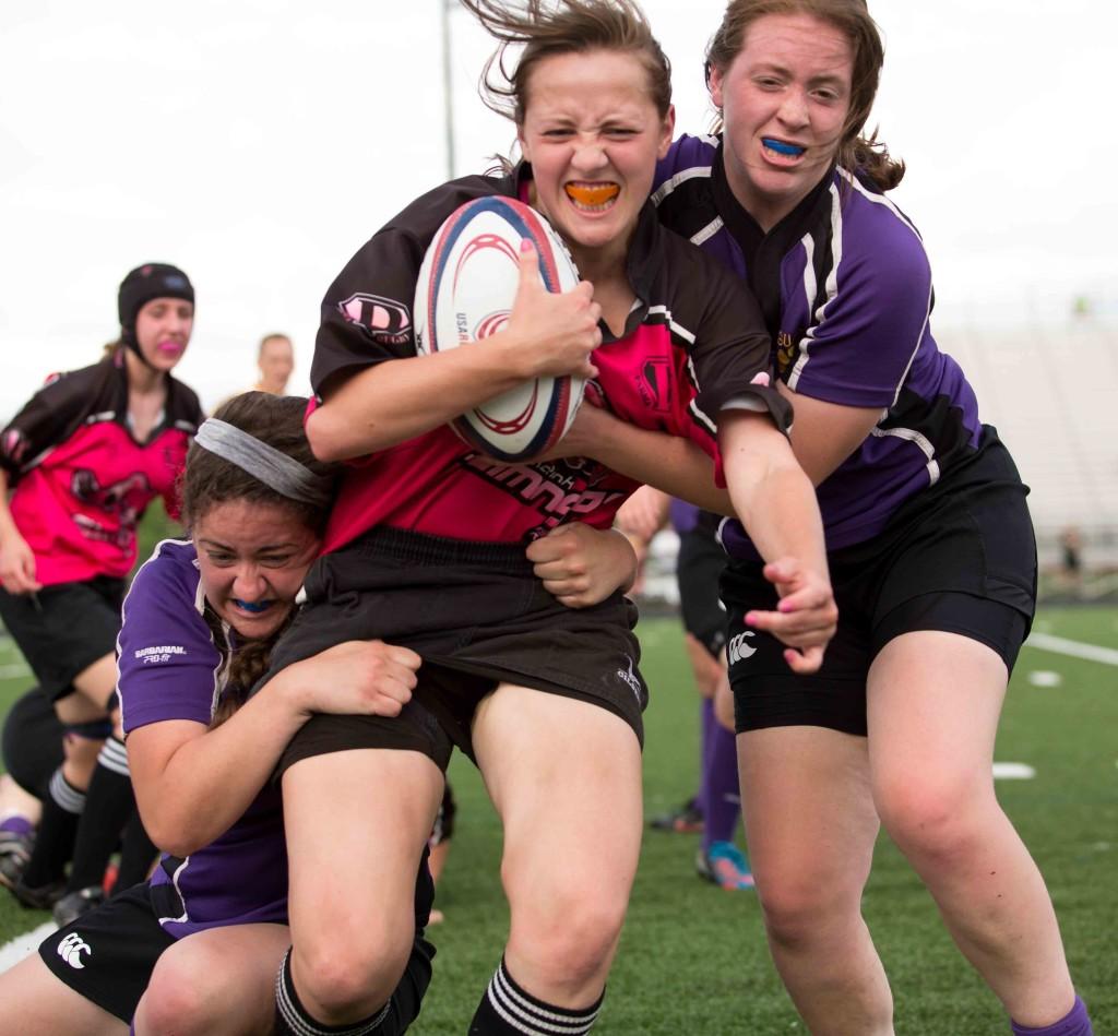 A member of the Parma High School womens rugby team, the Flamingos, struggles to escape the grasp of two St. Joseph Academy Jaguar opponents. Shakers womens rugby team will compete against St. Joseph in Division II play. 
