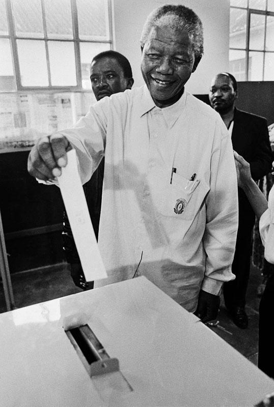 Mandela votes in the 1994 election, for the first time in his life.