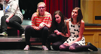 Members of the "Les Miserables" ensemble practice a scene in the Large Auditorium at an after-school rehearsal.