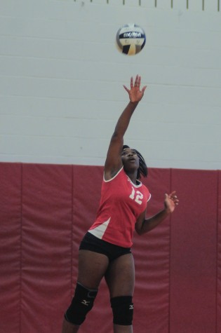 Senior volleyball player Nazhary Jackson hits the ball during a game against Beachwood High School Sept. 4.