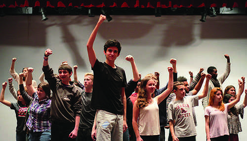 Led by junior Jack Bistriz as revolutionary Enjolras, the full cast of "Les Miserables: Student Edition," the Shaker Theater Department's fall production, rehearses a pivotal moment from the song "One Day More."