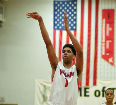 Senior Esa Ahmad  shoots a free throw during a home game against Mentor in 2014. Ahmad committed to play at Division I West Virginia University last November. He received 21 offers from Division I schools.  