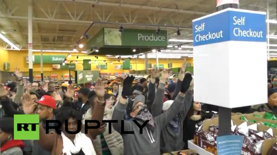 A screenshot of video footage by Ruptly TV of a hands up protest staged in a St. Louis Walmart.