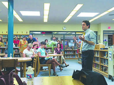 Middle School Principal David Glasner speaks to parents in the middle school library after he was hired last spring. One of Glasners first initiatives as principal has been instituting a new, standardized grading policy.
