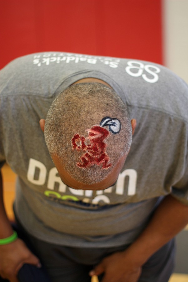Principal Michael Griffith proudly displays his bald head, painted with the Raider symbol.