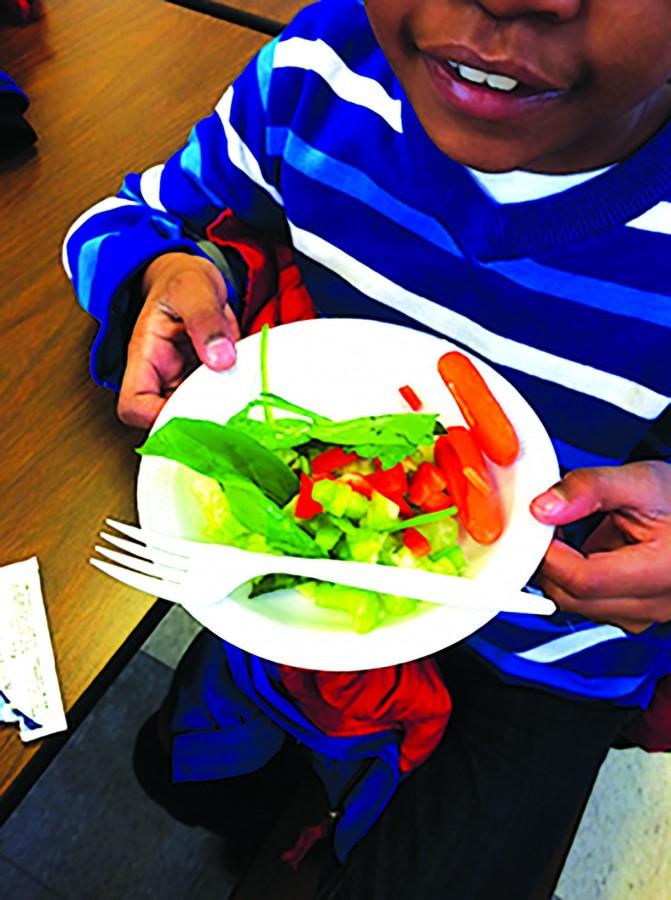 An excited student poses with his bowl of vegetables from the ‘Offering Bar’ ar Onaway. An Offering Bar bowl is only $1, and is planned to move to the high school and the other elementary schools in the future, according to AVI Director Amanda Schindley. 