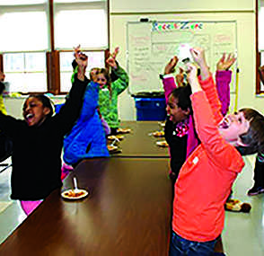 Onaway Elementary School third grade students cheer as their dish, spinach lasagna, wins during the menu tasting competition. Dish ideas brought up by the three third grade classes were tested to see which dish will be on the menu next year. 