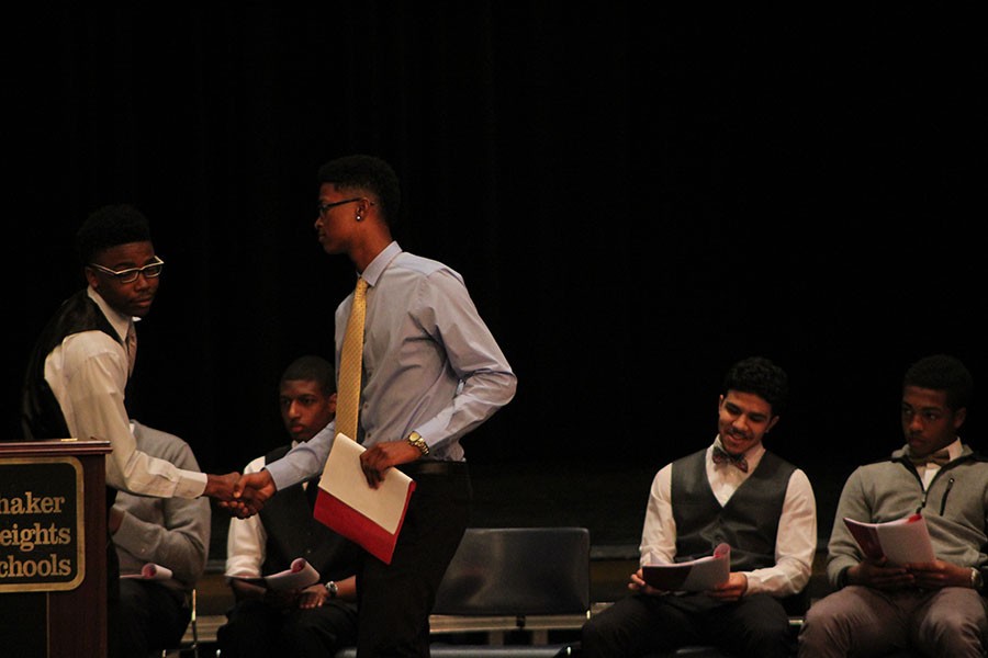 Isaiah+Archie+and+James+Kellon+shake+hands+on+stage+of+the+MAC+awards+program.