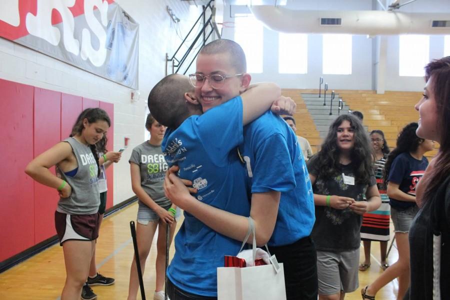 Freshman+Sophia+Solganik+and+Emma+Duhamel+embrace+after+both+shaving+their+heads+for+St.+Baldricks.