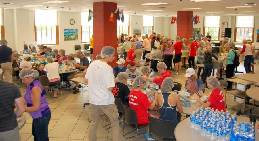 Volunteers packing the meals for Stop Hunger Now in the high school’s lower cafeteria.