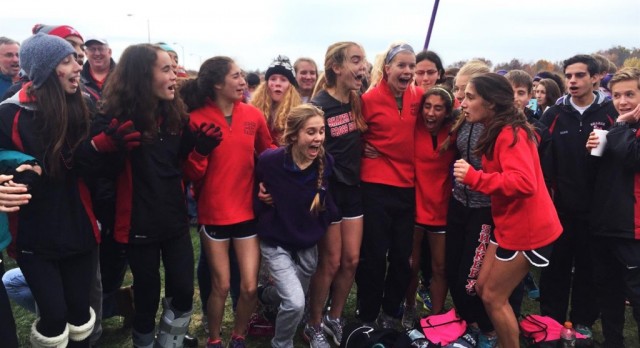 The Womens cross country team reacts after qualifying for states. The Raiders placed fourth at the regional final in Youngstown last Saturday. 