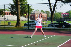 Senior Claire Hummel returns the ball during a match.