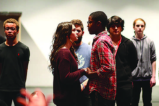 Juniors Emily Kenville and Tony Jones rehearse a scene as Romeo and Juliet in the high school’s large auditorium on Oct. 25.