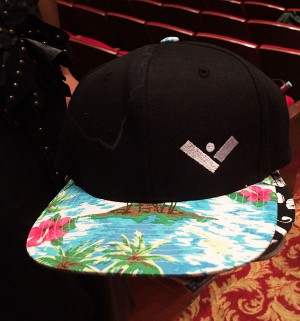 A hat displays the logo of Villain, a company that donated clothing to Fashion Club for the show.