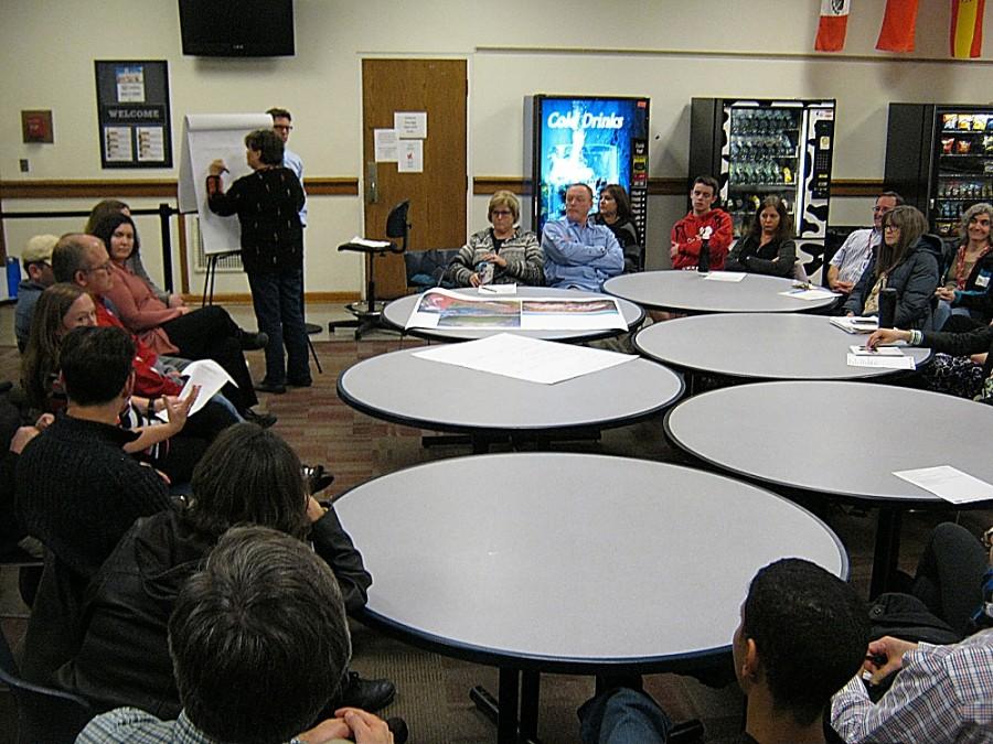 A group discusses one option for a master plan at a previous meeting in the upper cafeteria.