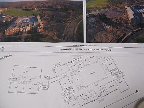 Blueprints and aerial photos of Onaway Elementary School lay untouched on cafeteria tables