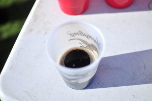 A cup filled with root beer and bearing the Yuengling beer label sits on the table near a game of “root beer pong” May 5, 2014.