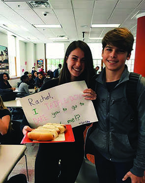 Sophmore Wilder Geier asked sophmore Rachel Podl to homecoming with a pun, a poster and some hot dogs. The poster reads, “Rachel, I TRIPLE DOG DARE you to go to homecoming with me!?” Geier asked Podl during lunchtime at her table. 