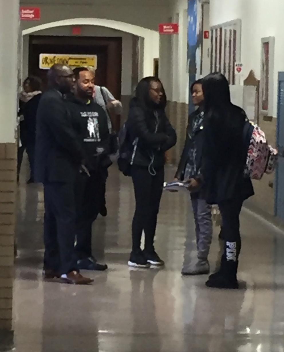 Superintendent Gregory C. Hutchings talks to students in the hallway Friday, Nov. 11.