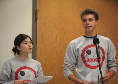 Core leaders and event organizers Isabel Wang and Jude Hinze-Gaines speak to participants about their group discussions.