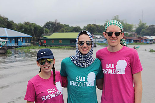 Senior Mimi Ricanati, sophomore Kevin LaMonica and senior Gus Mahoney wear Bald Benevolence T-shirts on a recent service trip to Cambodia.