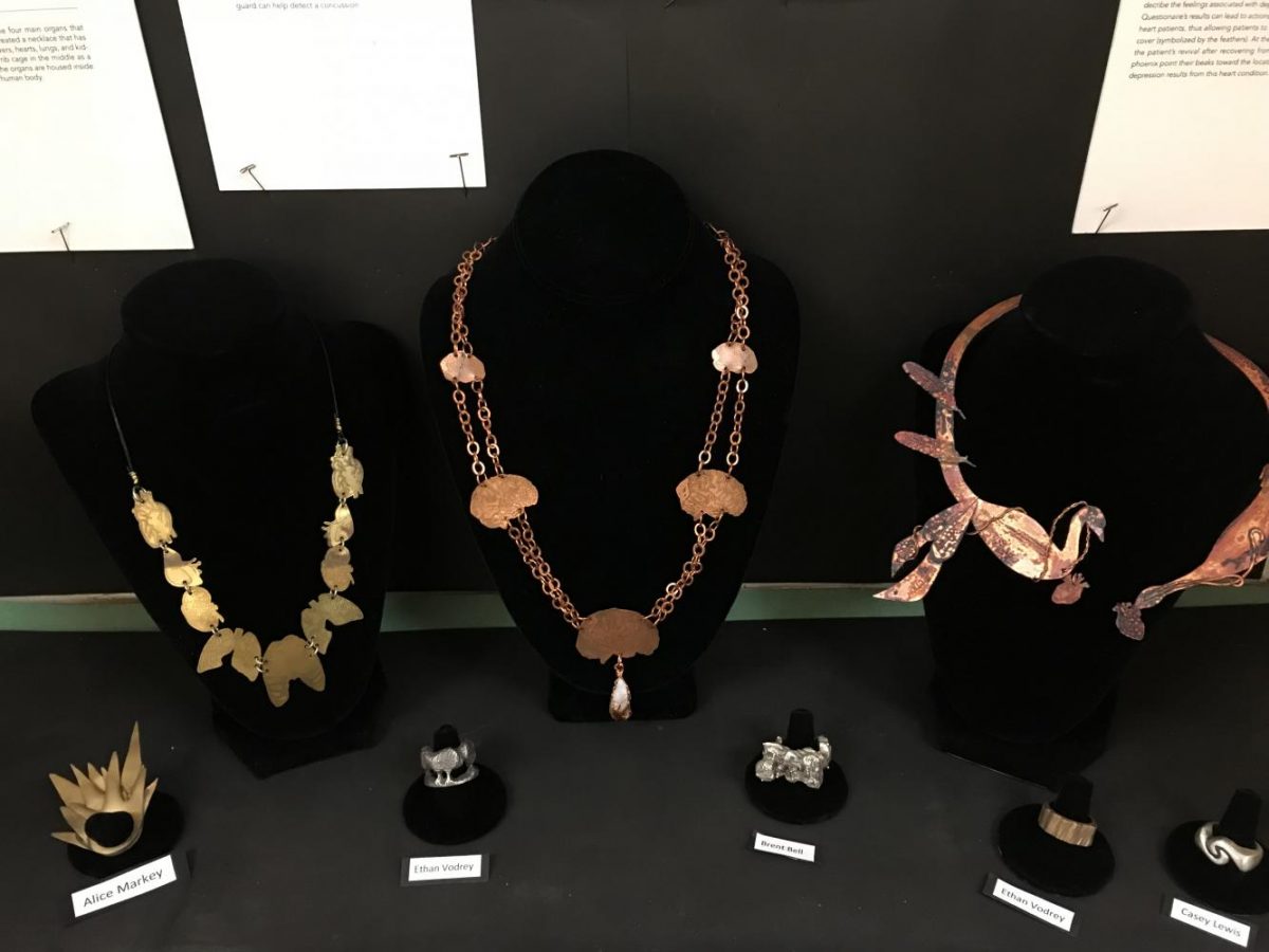 A case near the Main Office displays jewelry created by students for the Cleveland Clinic eXpressions Art Show.  Kathleen Fleming was recognized for helping her students participate in the program for five years.