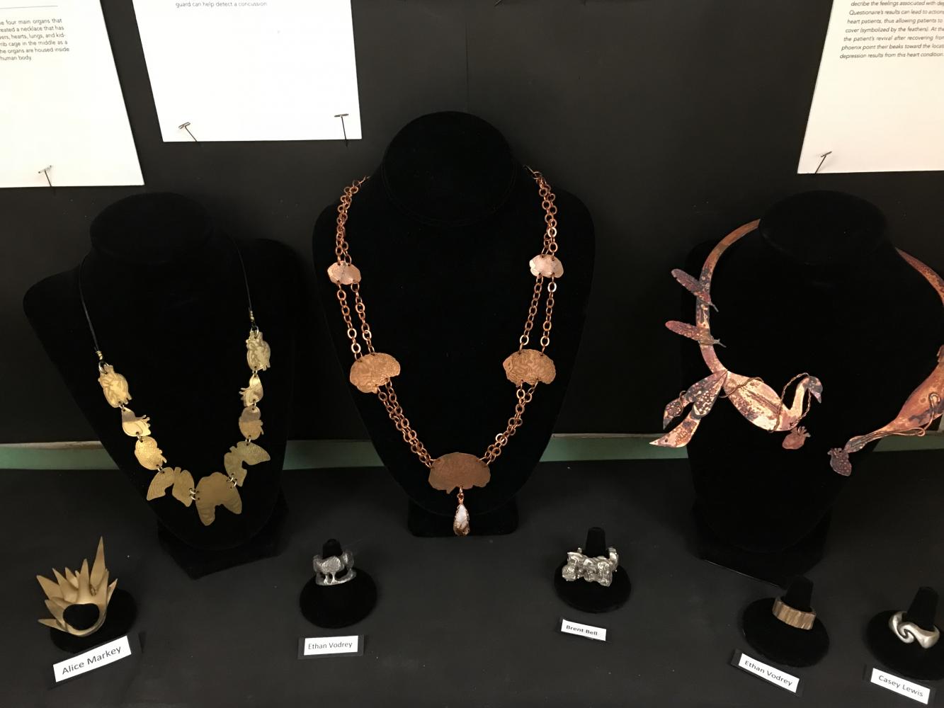 A case near the Main Office displays jewelry created by students for the Cleveland Clinic eXpressions Art Show. Kathleen Fleming was recognized for helping her students participate in the program for five years.
