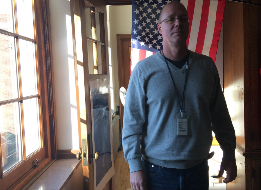 Tod Torrence, Army veteran and history teacher, in front of his classroom’s American Flag.