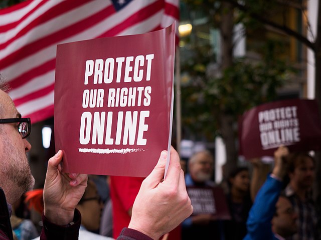 A protester holds a "Protect our rights online" sign at a rally in San Francisco, CA to protest the deregulation of the internet. “The FCC’s argument for the repeal was basically that regulations would hurt investments in broadband infrastructure,” said Gulani. “That’s also just false because broadband providers actually increased their investments when the regulation was put in place in 2015.”