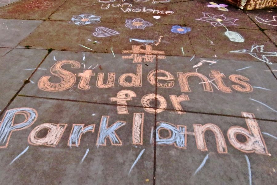 Students at Tamalpais High School in California held a vigil on Feb. 15, 2018, writing Students for Parkland on the sidewalk in support of victims. 