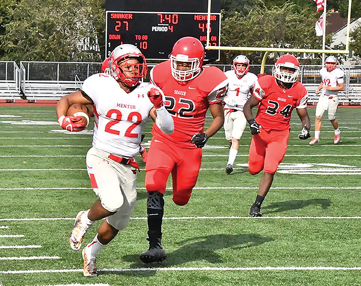 The News-Herald Mentors Elijah McDougal carries during the Cardinals victory over Shaker Heights on Oct. 7.