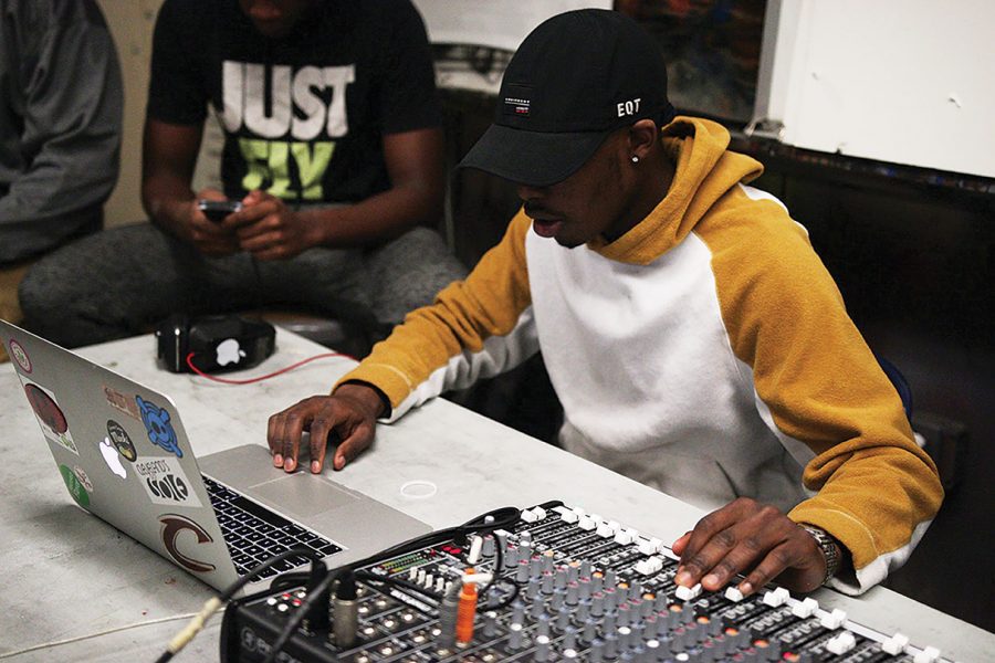 Producer Lawrence Butler (‘13), teaches Sankofa performers how to work a soundboard.

