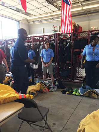 Izzy waits to put on her gear alongside her classmates at Tri Heights Fire Tech program. She is the only Shaker student enrolled in the program.