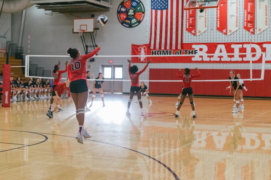 Freshman India Williams serves a ball, while the rest of the team is ready for the play to begin. Varsity volleyball team faces  Brunswick on Oct. 4.