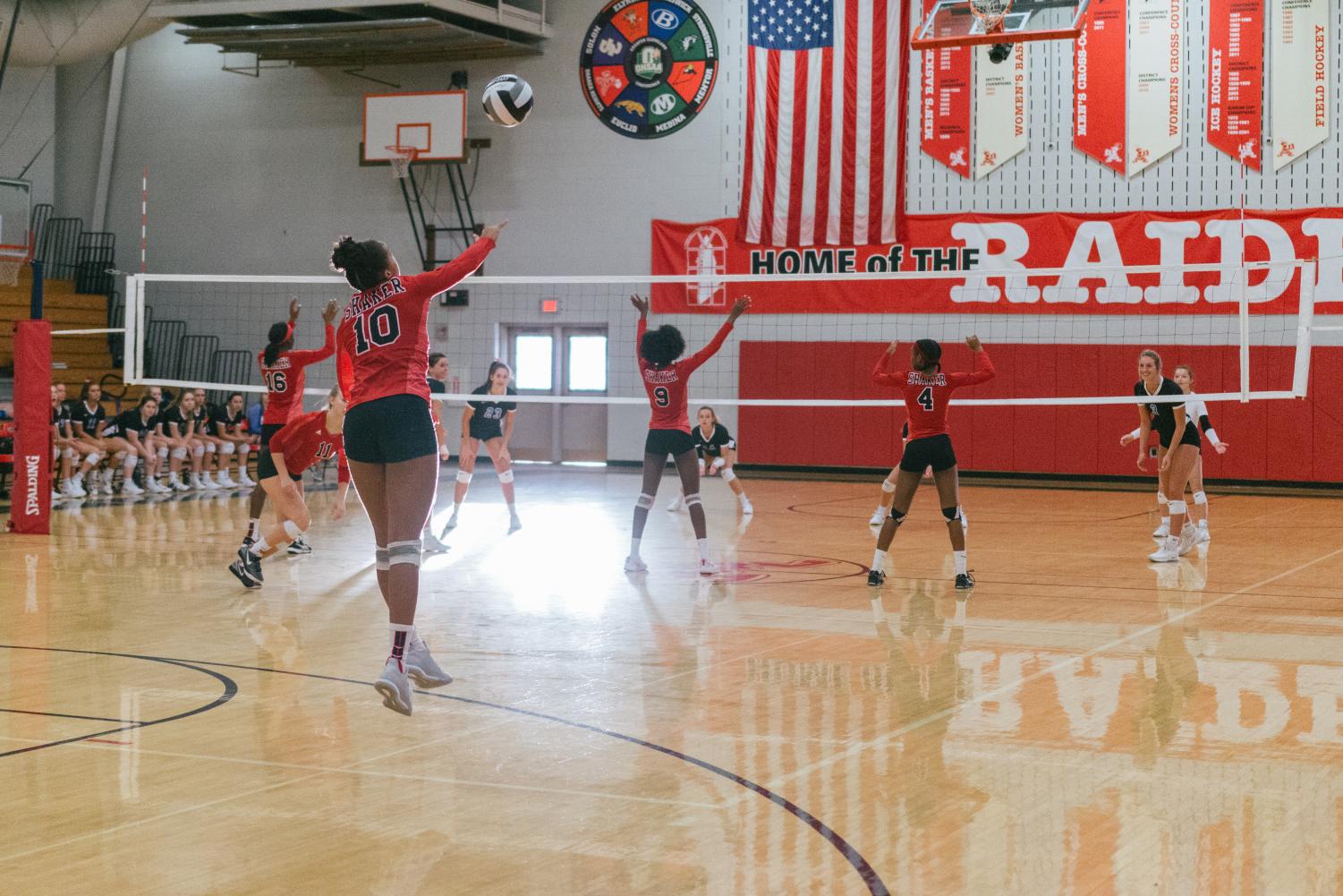 Freshman India Williams serves a ball, while the rest of the team is ready for the play to begin. Varsity volleyball team faces Brunswick on Oct. 4.