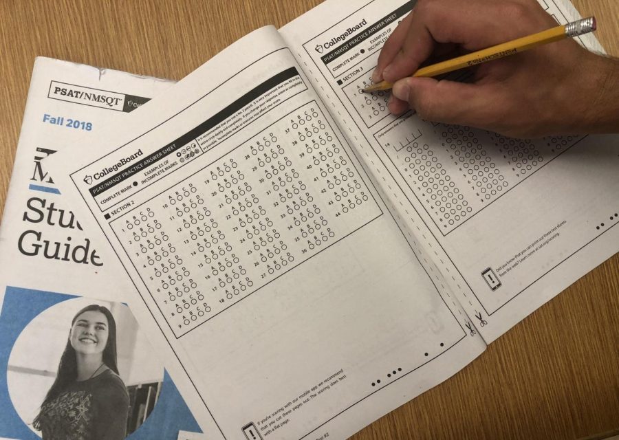Student takes a practice exam in his PSAT practice booklet. Ohio law requires that schools administer ACT or SAT to all grade 11 students and pays for the administration but does not require or support the PSAT. 