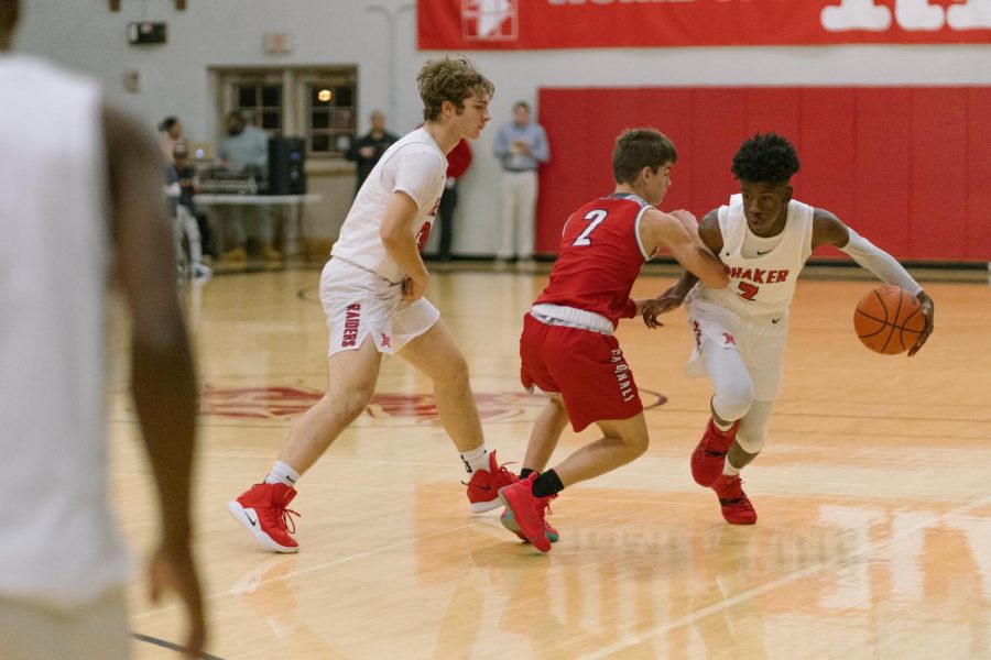 Freshman point guard Danny Young Jr. receives a screen from senior Harry Carroll against Mentor on Friday night. 
