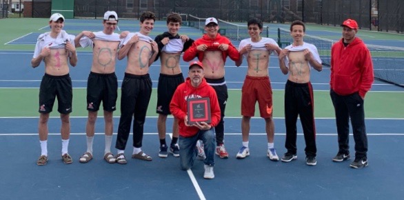 The mens team displays their support for Slawson April 16 after defeating Westlake for his 1,000th win. Slawson holds a plaque presented by Athletic Director Don Readance after the match.