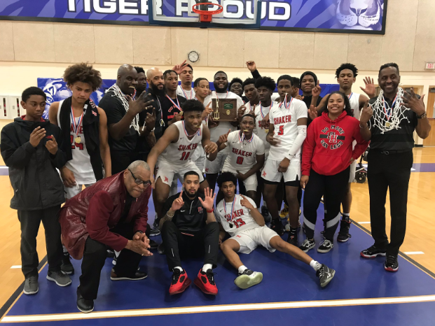 The men's basketball team after winning their district on Saturday.