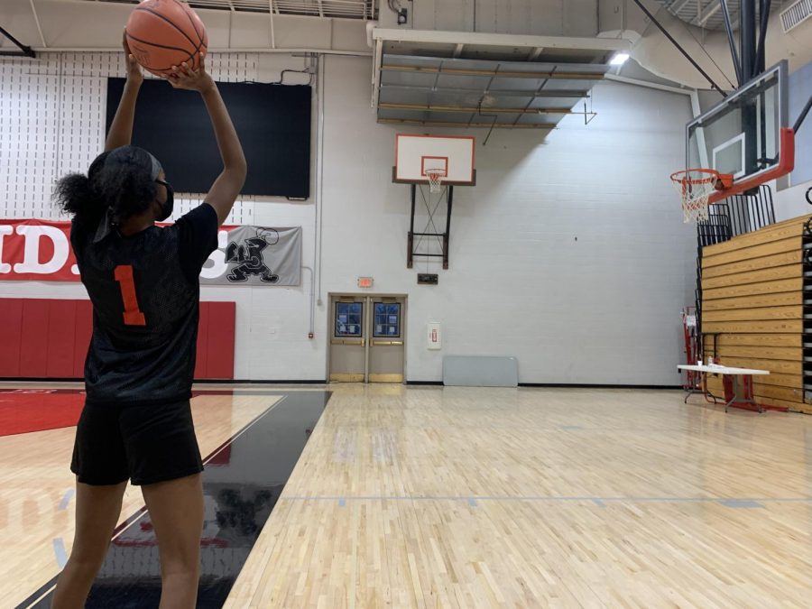 Sophomore Meilani Walker wears her mask as she plays basketball in a practice.