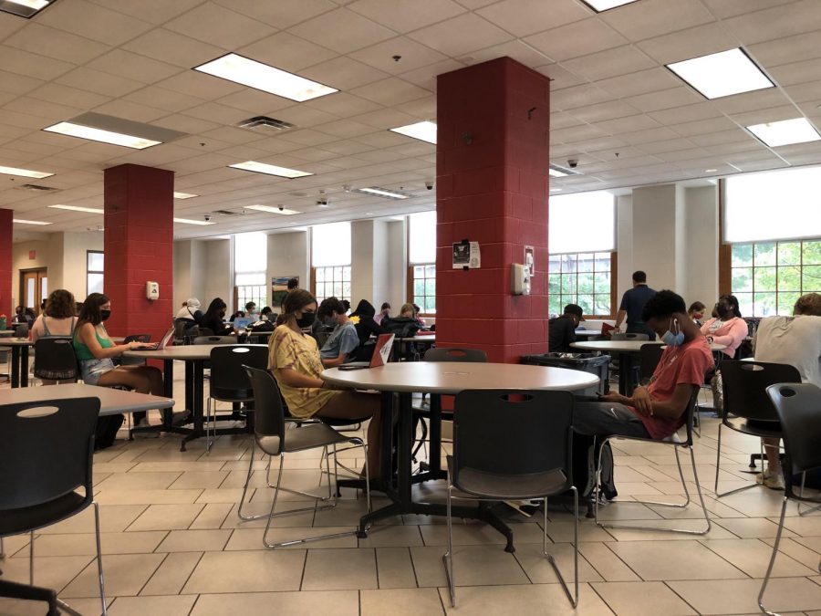 Students sit spread out wearing masks in the lower cafeteria for study hall.