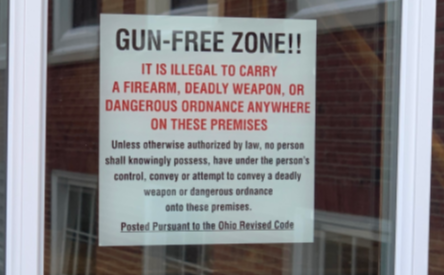 "Gun-Free Zone" signs are posted at high school building entrances