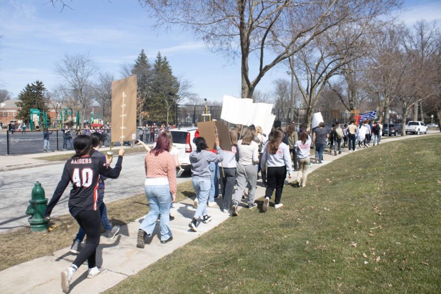 Students march past Bradley Gillettes third grade class outside Onaway.