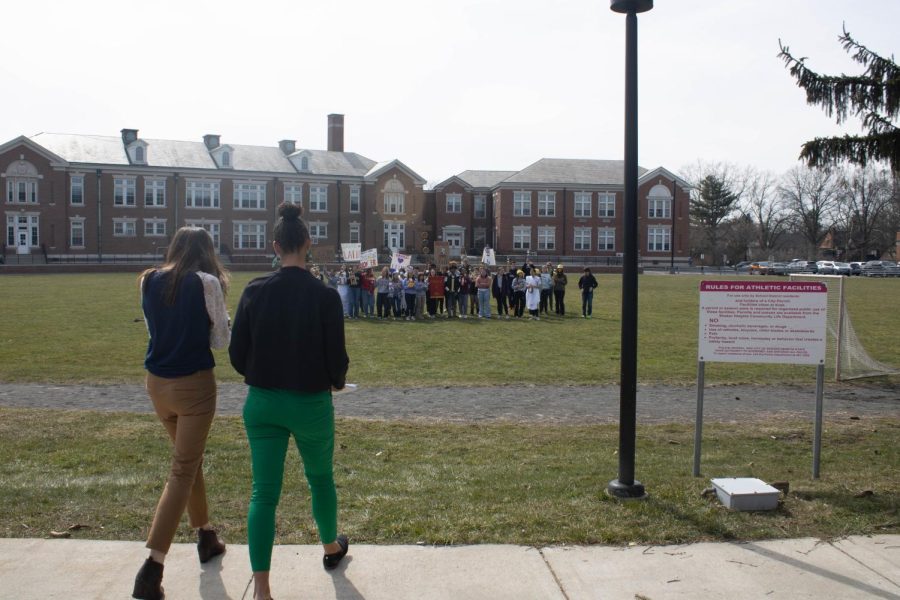 Communications Specialist Kristen Cash and Director of School Leadership Felicia Evans approach the marchers after exiting the administration building.