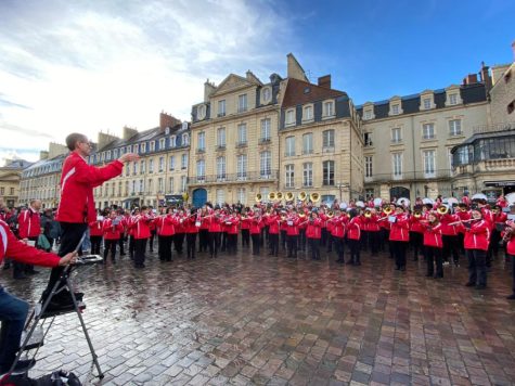 The band performs for residents of Caen. 