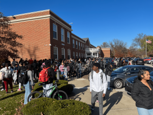 Students exit the building at 1:49 p.m. today. Students who could not leave immediately were permitted to remain in the lower cafeteria, where they were supervised by building security. Shaker Heights Police Department officers were also present. 
