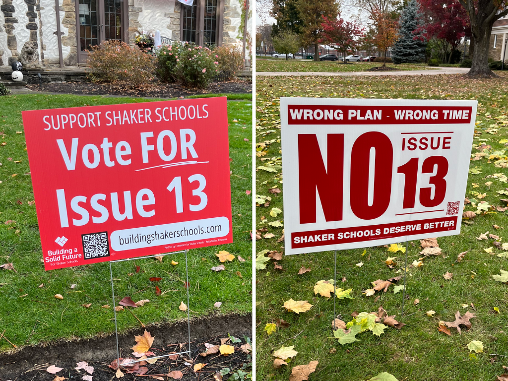 Yard signs for and against Issue 13 are posted around the city. The Committee for Shaker Schools supports the issue, while the Committee for Shakers Future opposes it. 