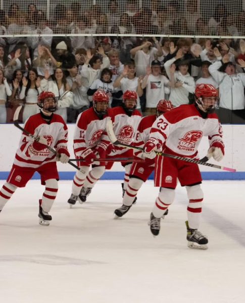 Freshman defenseman Cole Richard leads teammates Ryan Kilts, Quintin Garnett, Joey Moore and Connor Mayhugh to the bench after scoring a goal against Holy Name Dec. 1. Shaker won the game 9-1.