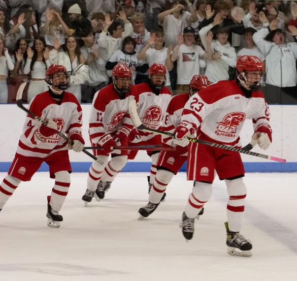 Freshman defenseman Cole Richard leads teammates Ryan Kilts, Quintin Garnett, Joey Moore and Connor Mayhugh to the bench after scoring a goal against Holy Name Dec. 1. Shaker won the game 9-1.